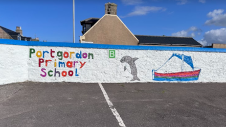 The image shows a colorful mural painted on the wall of Portgordon Primary School. The mural features the school name painted in bright multicolored letters.