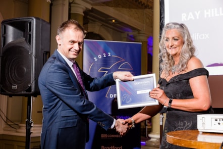 Sally Lyle receives her award from Tom Bridge, Operations Director of First West Yorkshire