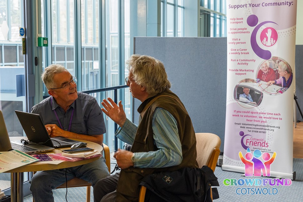 Image of residents receiving digital inclusion support from Cotswold Friends volunteers.