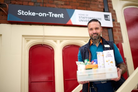 Zeb Nash, who volunteers as an Avanti West Coast Community Champion, with a collection box for donations made to Stoke-on-Trent Foodbank