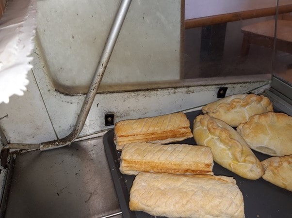 Emma's Sandwich 6: Food is pictured on a baking tray on a dirty looking surface