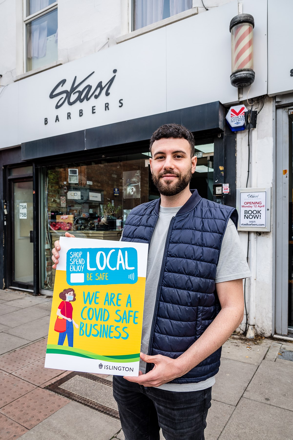 Pas Bertolino, of Stasi Barbers & Academy in Junction Road, Archway, promoting the Covid-Safe Business Award scheme window stickers