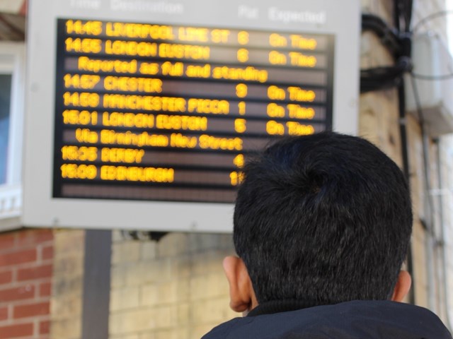Manchester Piccadilly takes part in nationwide sleepout to help runaway children: Railway Children Sleepout: Child (model) looking at departure board in station
