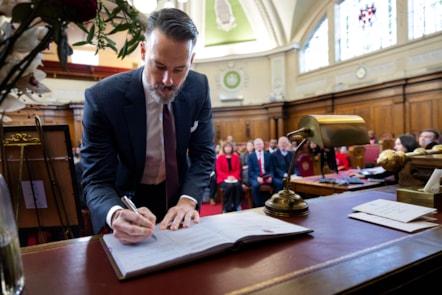 Josh Kroenke, Arsenal Co-Chair, signs the seal to confirm the Arsenal Women's team as Freepersons of Islington