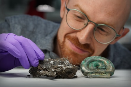 Dr Matthew Knight of National Museums Scotland with a clay mould from the Blyth Hoard and a fitting from the Peebles Hoard that the mould was used to make Image credit Stewart Attwood