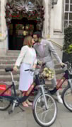Nicolas Moura and his wife with Santander Cycles on the steps of Chelsea Old Town Hall surrounded by flowers of their wedding day in 2024: Nicolas Moura and his wife with Santander Cycles on the steps of Chelsea Old Town Hall surrounded by flowers of their wedding day in 2024