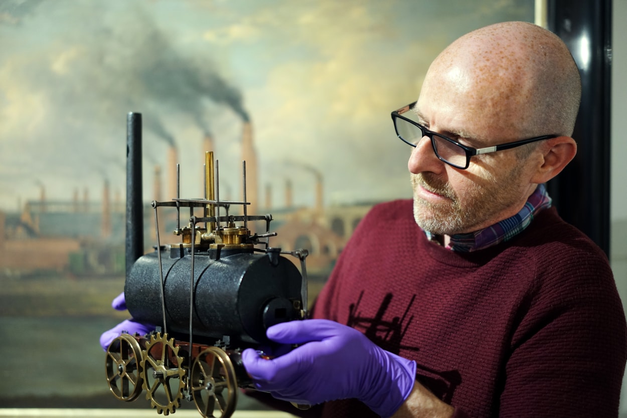 Miniature loco scans: John McGoldrick, Leeds Museums and Galleries' curator of industrial history, with the model of Salamanca.