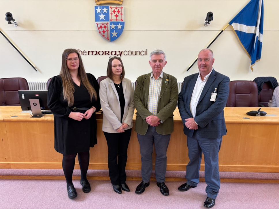 Councillor Amber Dunbar, Kathleen Donaldson from Sacro, Councillor Donald Gatt and John Kennedy from Sacro standing in the Moray Council chambers