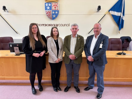 Councillor Amber Dunbar, Kathleen Donaldson from Sacro, Councillor Donald Gatt and John Kennedy from Sacro standing in the Moray Council chambers