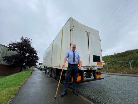 Cllr Damian Corfield next to an abandoned trailer of tyres in Narrowboat Way, Brierley Hill.