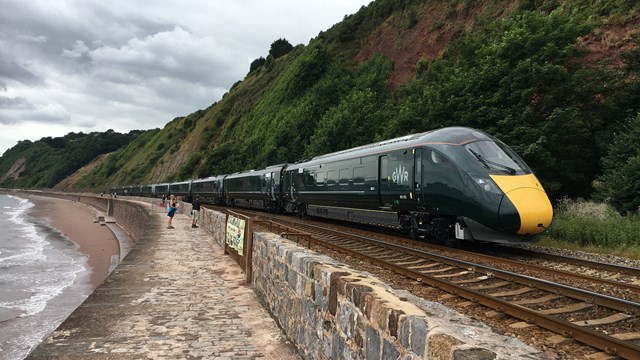 A GWR train passes along the stretch of railway between Holcombe and Teignmouth