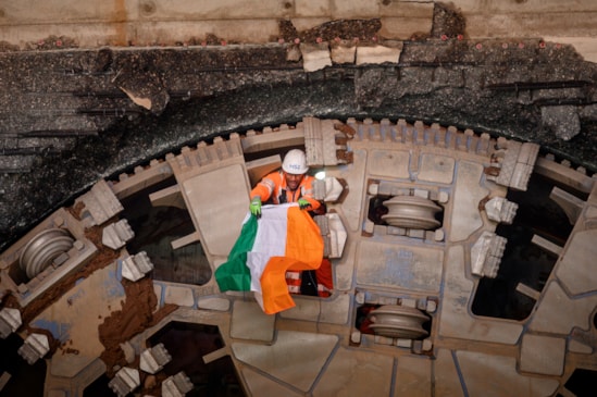 HS2 tunnelling miner holds flag of the Republic of Ireland after completing the tunnelling breakthrough of TBM Mary Ann in Birmingham: The flags represent the nationality and regions of the expert tunnelling teams who have completing the tunnelling mission

Location: Bromford portal west, Washwood Heath, Birmingham
