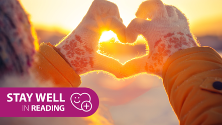 Stay Well in Reading this Winter: Person wearing gloves making the shape of a heart with their hands