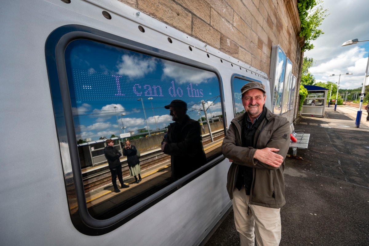 Award-winning artist, Rob Mulholland, with Hope in Hamilton art installation he developed with local community