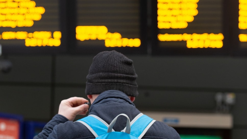 Image shows customer at departure screens