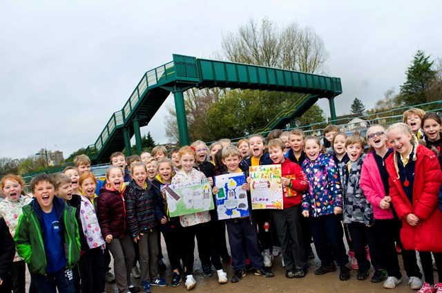 Magor Primary School pupils show off their railway safety posters at the new Whitewall footbridge