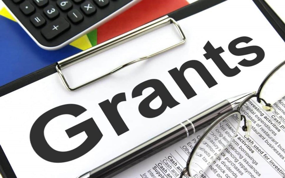 Graphic of a piece of paper with the word "Grants" on it