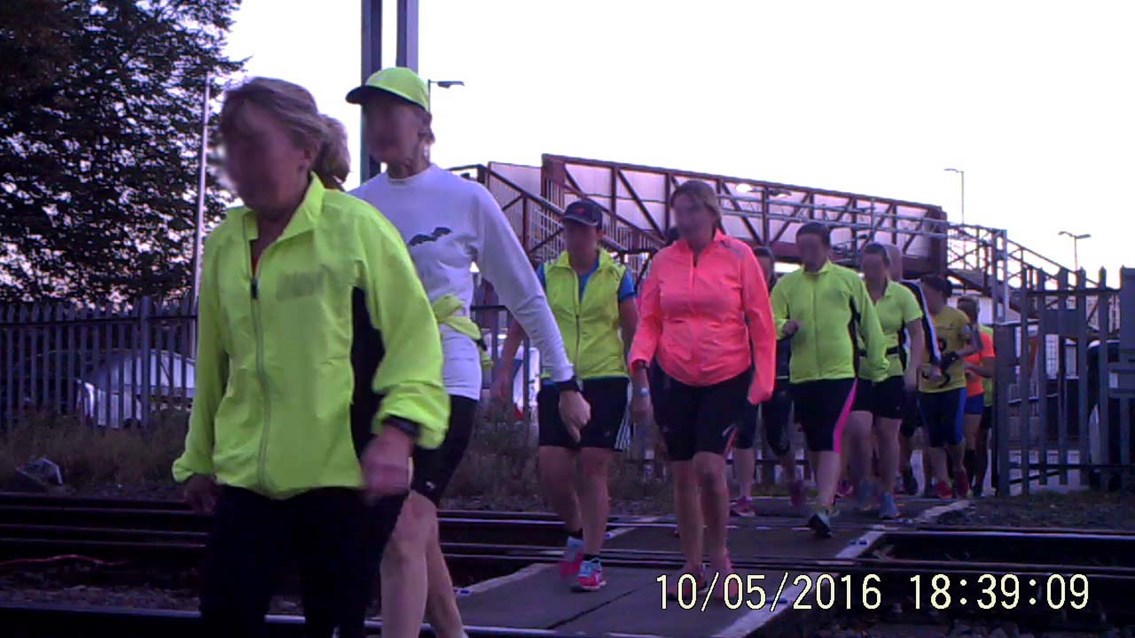 Large group crosses Stone station level crossing