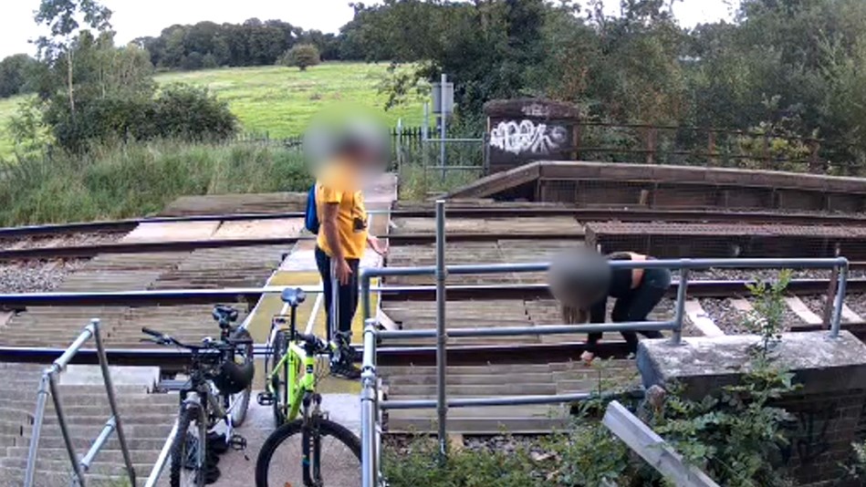 Two people misusing Calcot Mill level crossing