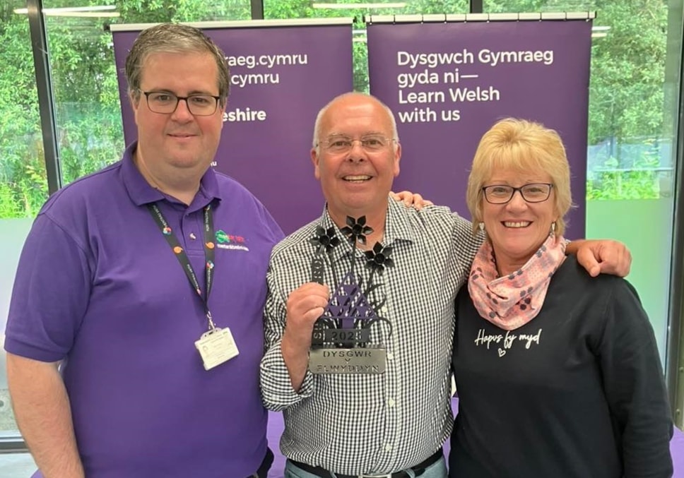 Kevin Davies with his tutor Buddug Harries and Rhidian Evans, Chief Officer of Menter Iaith Sir Benfro.