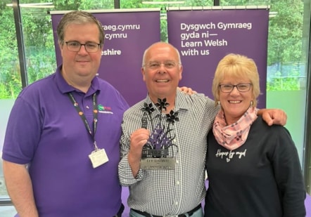 Kevin Davies with his tutor Buddug Harries and Rhidian Evans, Chief Officer of Menter Iaith Sir Benfro.