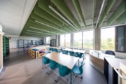 Wester Hailes HS learning space: A view of a learning space at Wester Hailes High School, featuring mixed seating, shelving and large windows with a view of trees