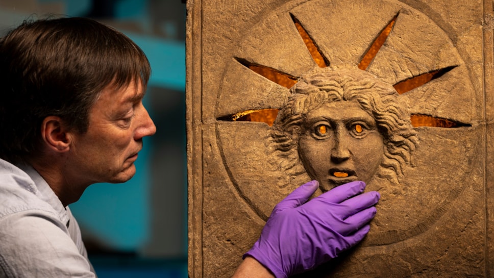 Curator Dr Fraser Hunter examines the Roman altars.Photo © Duncan McGlynn (4)