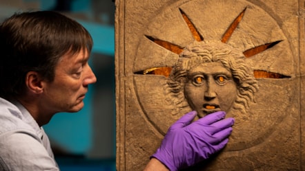 Curator Dr Fraser Hunter examines the Roman altars.Photo © Duncan McGlynn (4)
