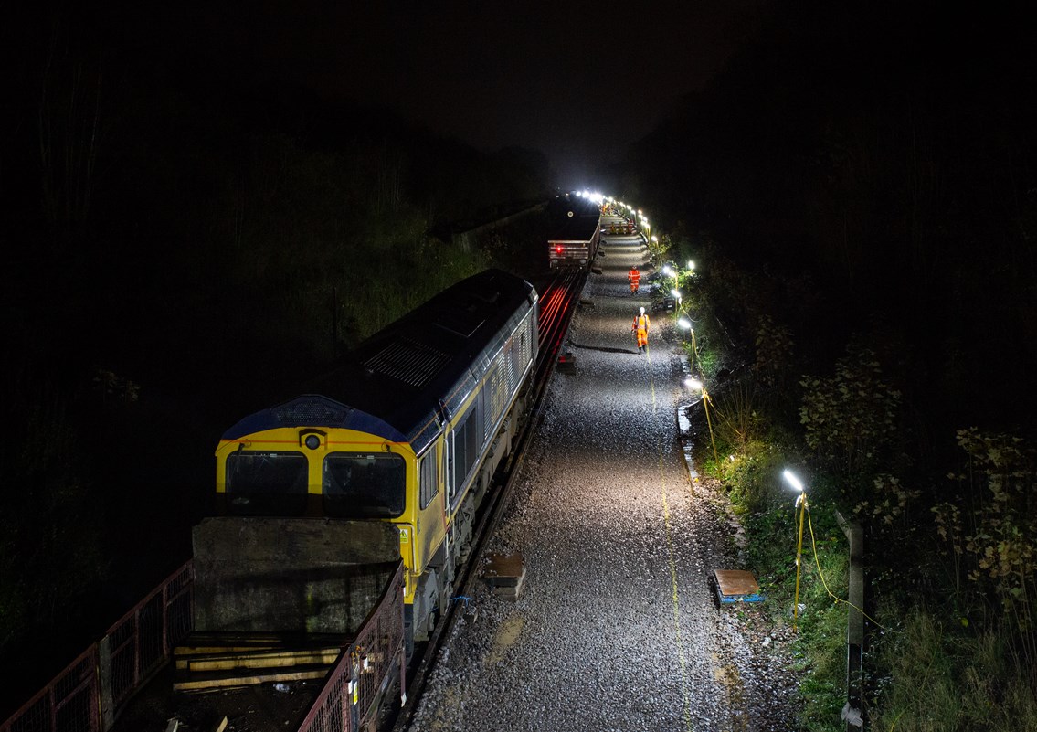 engineering train at night: Engineering train delivering sleepers to a worksite in Whitstable