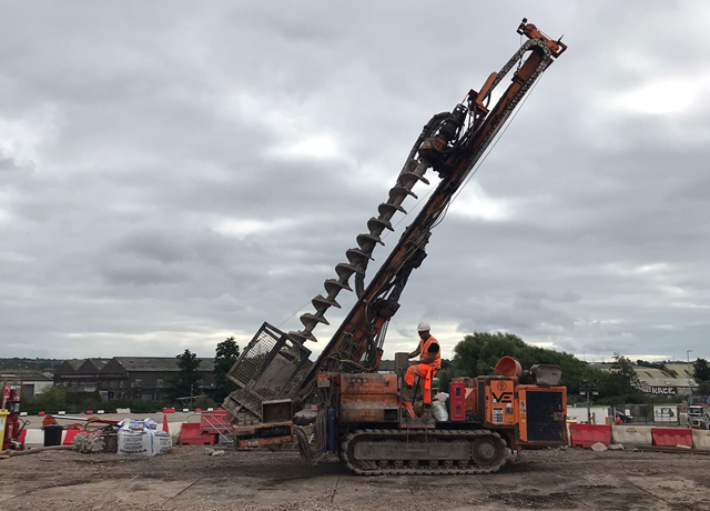 One of the large piling drills being driven by an operative
