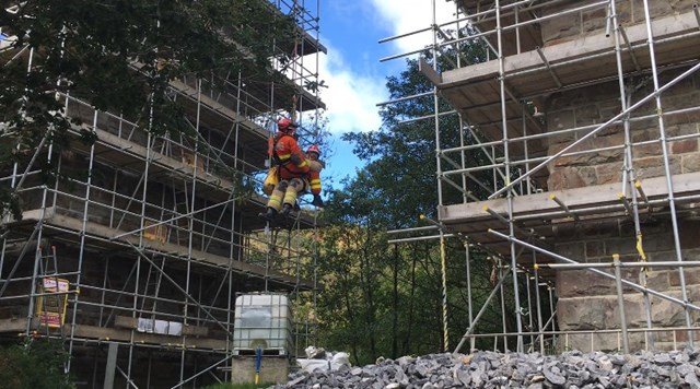 Fire fighters abseiled from the top of the 100ft high structure to perform a mock rescue