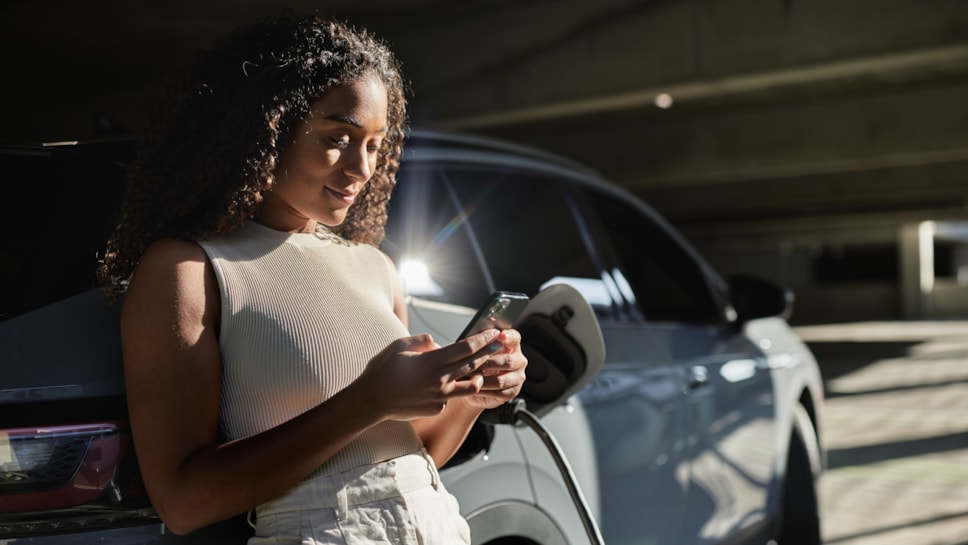 EV charging woman leaning