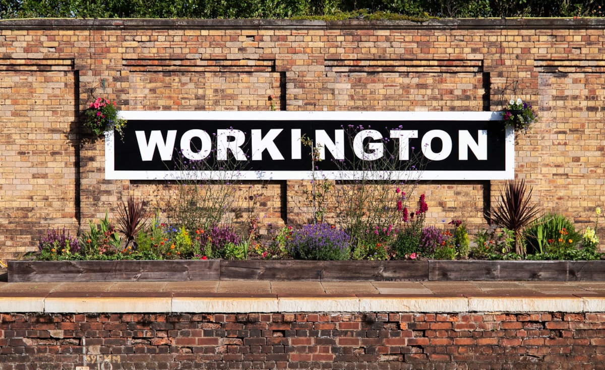 Image shows Workington station signage