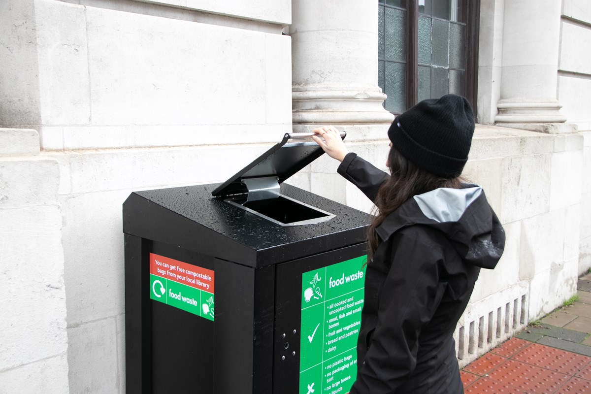 A resident makes use of one of the food waste bins that are being trialled on Holloway Road