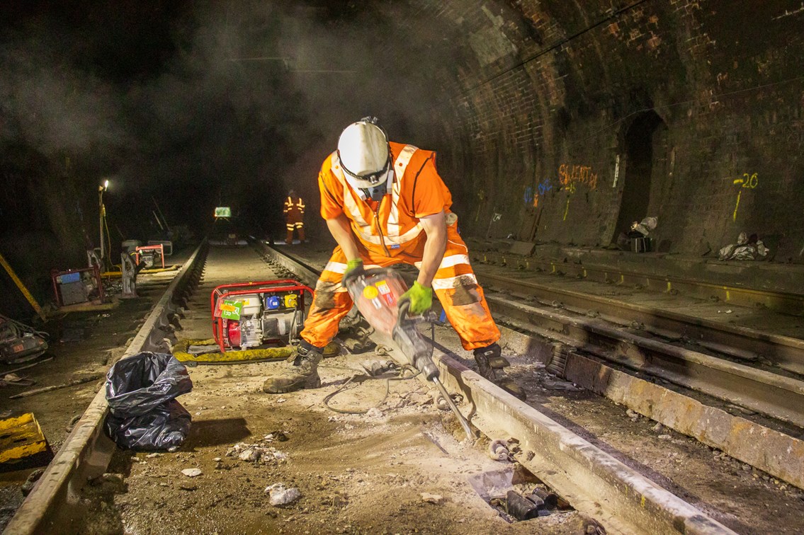 Engineering Works in tunnel: Engineer working on tracks in a tunnel