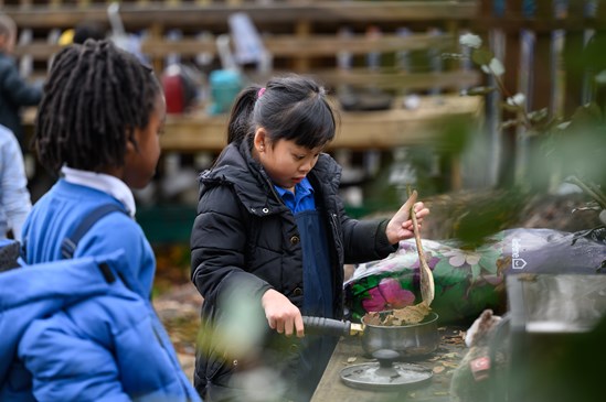 Pupils at Paget Primary School in the mud kitchen in the Forest School