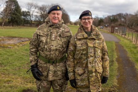 Two Army personnel - one male and one female - in army khaki camouflage uniforms