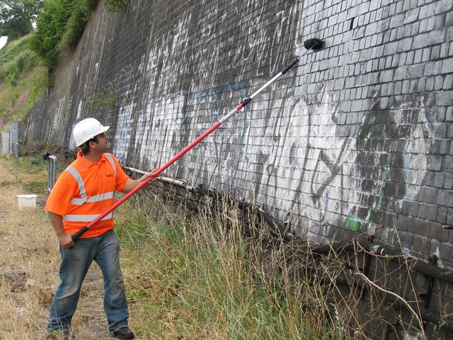 Graffiti clear up - Bristol Temple Meads: Maintenance undertake painting out of graffiti on wall as part of the one mile clean up either side of Bristol Temple Meads station - 31 July 2006
