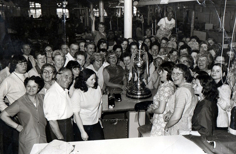 Leeds Libraries needs your help to capture names for city’s family album: Hepworths Ltd staff with the 1974 football league trophy. Copyright: Leeds Libraries, Leodis.net