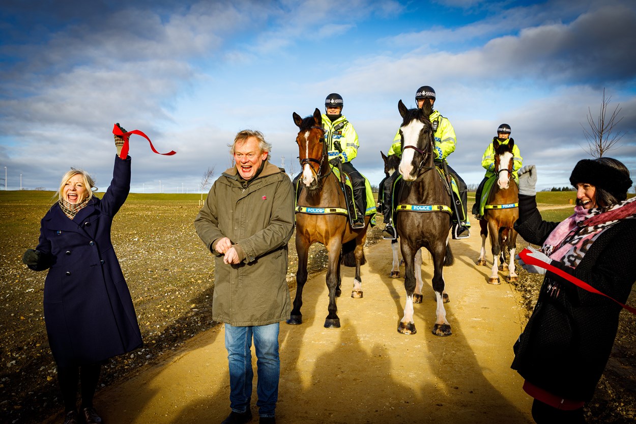 Martin Clunes cuts ribbon on East Leeds Orbital Route equestrian route: Councillor Helen Hayden, Executive Member for Infrastructure and Climate and the West Yorkshire Mayor, Tracy Brabin hold ribbon that the President of The British Horse Society, Martin Clunes has cut to commemorate award for 