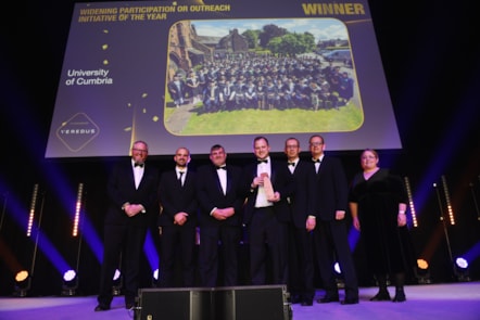 University of Cumbria team on stage at the 2024 Times Higher Education Awards after winning an award