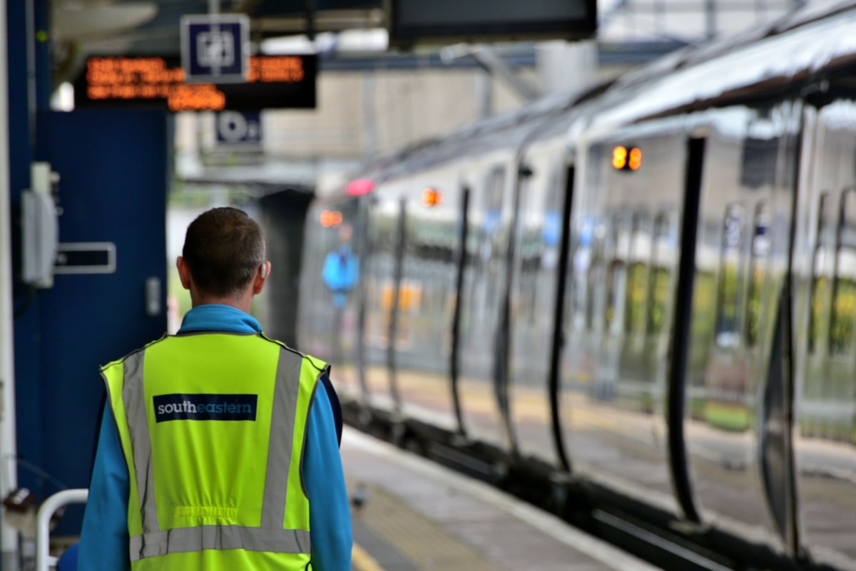 Stock image of a train and a Southeastern employee
