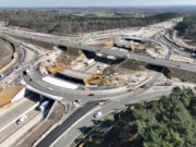 M25 J10 gyratory 2: An aerial view of the new gyratory at M25 J10. The bridge that will be demolished this weekend can be seen in the background, with the bridge that will be demolished in two weeks' time in the foreground.