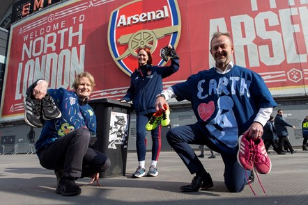 Cllr Champion, Helen Staniland from Arsenal in the Community, and Keith Townsend holding up shoes to be donated