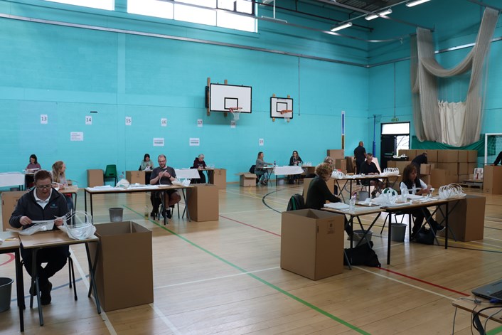 Carr Manor PPE Project: Volunteers in the school hall at Carr Manor Community School making vital PPE for health workers.