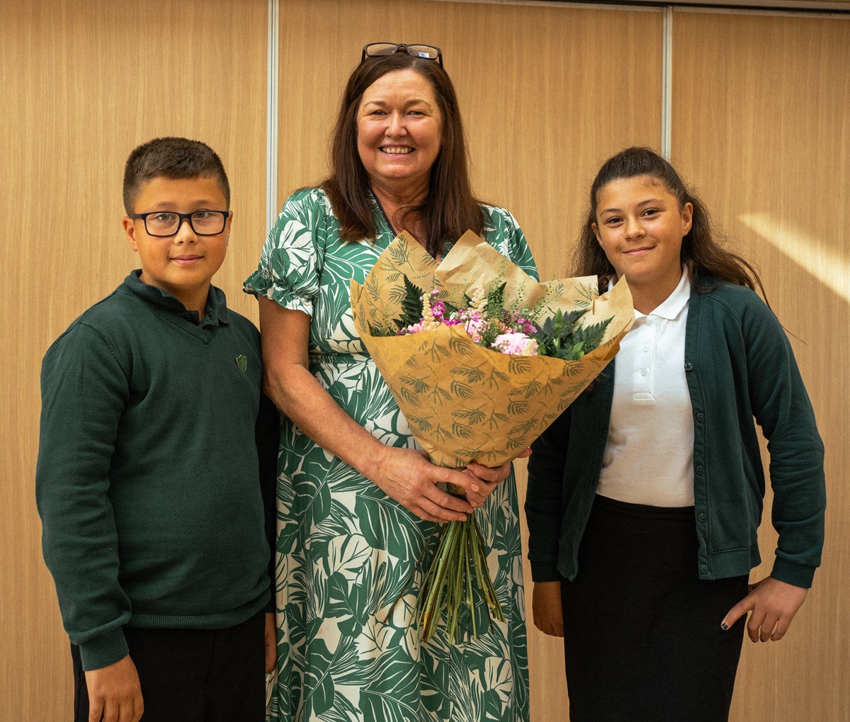 Nathan and Emma present flowers to Head Teacher Mrs Gaitens