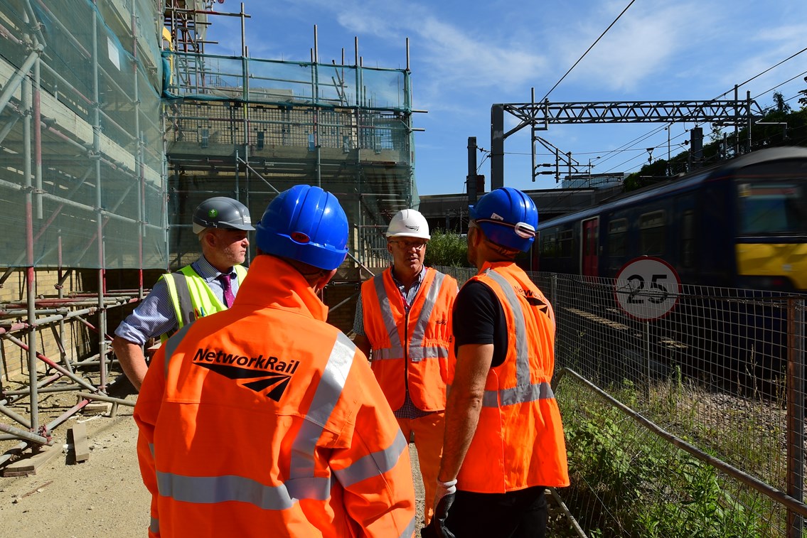 Engineer team briefing on worksite next to the railway: Open for Business, OfB, Engineer, Asset Protection and Optimisation, ASPRO, partnership, partner, client, third party, outside party, railway, building, construction, generic, worker, worksite, work, team briefing