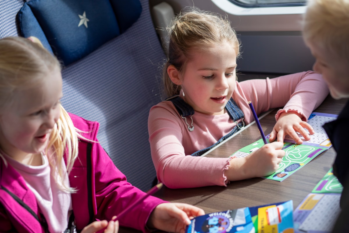 Lucy, 7, Ivy, 7 and Ethan, 4, work their way through the new TPE activity book