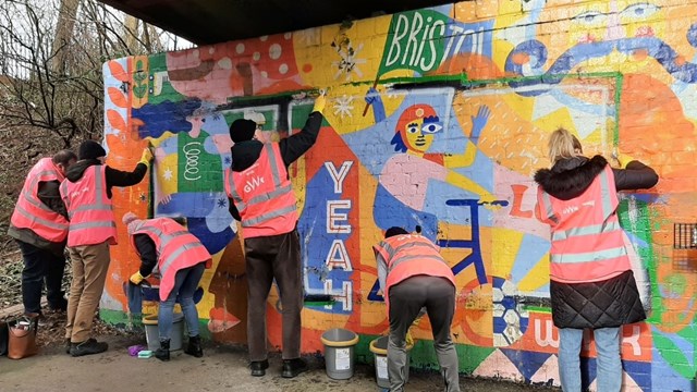 Network Rail volunteers help to restore two Bristol murals previously damaged by graffiti: Cleaning up the murals