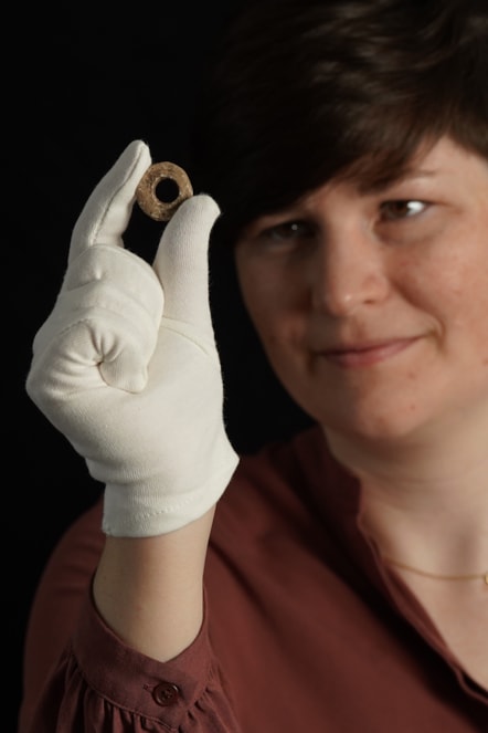 Janel Fontaine, Treasure Trove Officer, with the Medieval spindle whorl. Photo (c) Stewart Attwood. (1)